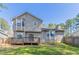 Backyard features a wooden deck, gray siding, a bay window, and a full green lawn at 971 Lake Watch Ct, Stone Mountain, GA 30088