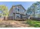 Backyard featuring a wooden deck, gray siding, a bay window, and a full lawn with foliage at 971 Lake Watch Ct, Stone Mountain, GA 30088