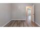 Bedroom with neutral walls, modern floors and a bright doorway leading to other rooms at 971 Lake Watch Ct, Stone Mountain, GA 30088