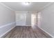 Bright bedroom features neutral walls, modern gray floors, white trim, and closet with double doors at 971 Lake Watch Ct, Stone Mountain, GA 30088