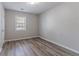 An empty bedroom features gray walls, modern floors and a bright window overlooking the property at 971 Lake Watch Ct, Stone Mountain, GA 30088