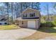 Side view of the home showing the driveway and the attached one-car garage at 971 Lake Watch Ct, Stone Mountain, GA 30088