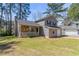 Charming home with a stone porch, gray siding, and a lush front yard at 971 Lake Watch Ct, Stone Mountain, GA 30088