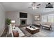 Cozy living room featuring a stone fireplace and lots of natural light at 971 Lake Watch Ct, Stone Mountain, GA 30088