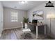 A staged office boasts a modern rug, simple desk and decor, and a bright window at 971 Lake Watch Ct, Stone Mountain, GA 30088