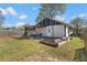 A spacious backyard with a wooden deck, pergola, and raised garden beds offers a relaxing outdoor retreat at 1479 Hartford Sw Ave, Atlanta, GA 30310