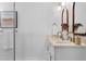 Modern bathroom featuring double vanity with stone countertops, gold fixtures, and ample lighting at 1479 Hartford Sw Ave, Atlanta, GA 30310