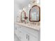 Bright bathroom featuring double vanity, quartz countertops, wood framed mirrors, and modern fixtures at 1479 Hartford Sw Ave, Atlanta, GA 30310