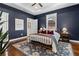 Relaxing bedroom featuring a cozy bed, tray ceilings, hardwood floors, and ample natural light at 1479 Hartford Sw Ave, Atlanta, GA 30310