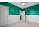Inviting bedroom with vibrant accent wall, features views of the kitchen, and white trim at 1479 Hartford Sw Ave, Atlanta, GA 30310