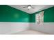 Cheerful bedroom boasts a two-tone color scheme, plush carpeting, and a ceiling fan at 1479 Hartford Sw Ave, Atlanta, GA 30310