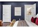 Stylish bedroom with access to ensuite bathroom, featuring dark blue walls and hardwood floors at 1479 Hartford Sw Ave, Atlanta, GA 30310