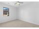 Bright, empty bedroom with carpet floors and a large window at 1479 Hartford Sw Ave, Atlanta, GA 30310