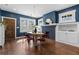 Elegant dining room with hardwood floors, natural light, statement lighting, and sophisticated color palette at 1479 Hartford Sw Ave, Atlanta, GA 30310