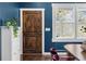 Inviting entry featuring a stained wood door, white trim, stylish hardware, and navy blue walls at 1479 Hartford Sw Ave, Atlanta, GA 30310