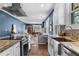 Open concept kitchen with granite countertops, stainless appliances, and view into the living room at 1479 Hartford Sw Ave, Atlanta, GA 30310