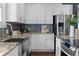 Well-lit kitchen featuring white cabinets, granite countertops, stainless steel appliances, and a modern faucet at 1479 Hartford Sw Ave, Atlanta, GA 30310