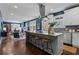 Open concept kitchen with stainless appliances, modern countertops, and an island with barstool seating at 1479 Hartford Sw Ave, Atlanta, GA 30310