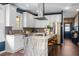 Spacious kitchen with stainless appliances, white cabinets, island with seating, and hardwood floors at 1479 Hartford Sw Ave, Atlanta, GA 30310