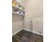 Empty laundry room with tile floors and open shelving at 1479 Hartford Sw Ave, Atlanta, GA 30310