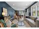 Spacious living room featuring hardwood floors, modern furnishings, and large windows, showcasing a cozy atmosphere at 1479 Hartford Sw Ave, Atlanta, GA 30310