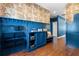 Well-lit mudroom with built-in storage, coat racks, bench, and dark hardwood floors at 1479 Hartford Sw Ave, Atlanta, GA 30310