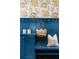Built-in storage and seating in stylish mudroom featuring colorful designer wallpaper at 1479 Hartford Sw Ave, Atlanta, GA 30310