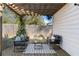 Relaxing patio under a pergola featuring chic outdoor furniture and a patterned rug at 1479 Hartford Sw Ave, Atlanta, GA 30310