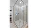 Modern shower with textured tile, glass surround, and updated fixtures in a renovated bathroom at 1479 Hartford Sw Ave, Atlanta, GA 30310