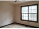 Bedroom featuring a large window and neutral walls with contrasting trim at 2425 River Place Xing, Douglasville, GA 30135