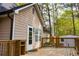 Home exterior with wooden deck, white trim and neutral siding at 2425 River Place Xing, Douglasville, GA 30135