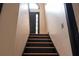 Staircase leading to front door with glass accent at 2425 River Place Xing, Douglasville, GA 30135
