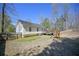 A fenced backyard with a wooden deck, a playset, and a grassy area at 114 Connie Dr, Dallas, GA 30157