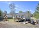 A fenced backyard with a wooden deck, a playset, and a grassy area at 114 Connie Dr, Dallas, GA 30157