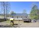 A fenced backyard with a wooden deck, a playset, and a grassy area at 114 Connie Dr, Dallas, GA 30157