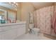 Well-lit bathroom featuring a shower with a beautiful palm tree-themed curtain at 114 Connie Dr, Dallas, GA 30157