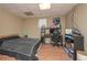 A bedroom with a bed, an office chair, and hardwood laminate flooring at 114 Connie Dr, Dallas, GA 30157