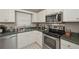 Efficient kitchen with white cabinets and stainless steel appliances, including a modern range at 114 Connie Dr, Dallas, GA 30157