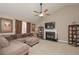 Cozy living room featuring a fireplace, vaulted ceilings, and plush sectional sofa at 114 Connie Dr, Dallas, GA 30157