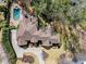 Aerial view showcasing the large home, backyard pool, patio, and surrounding mature trees at 303 Rolling Rock Se Rd, Marietta, GA 30067