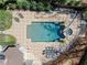 Aerial view showcasing the pool, outdoor seating and patio with lush landscaping at 303 Rolling Rock Se Rd, Marietta, GA 30067