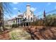 Back exterior view of house with large deck, patio, and landscaped yard at 303 Rolling Rock Se Rd, Marietta, GA 30067
