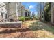 Spacious backyard featuring mature trees and lawn with patio area for relaxing at 303 Rolling Rock Se Rd, Marietta, GA 30067