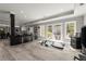 Open-concept basement featuring a kitchen, dining area, and access to outdoor patio through glass doors at 303 Rolling Rock Se Rd, Marietta, GA 30067