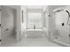 Bright bathroom featuring soaking tub, glass block window, tiled shower and neutral tile flooring at 303 Rolling Rock Se Rd, Marietta, GA 30067