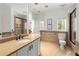 Well-lit bathroom features double sinks, stylish mirrors, tiled shower with glass door, and neutral tones at 303 Rolling Rock Se Rd, Marietta, GA 30067