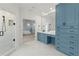 Spacious blue and white bathroom featuring a large shower, custom vanity, and tile flooring at 303 Rolling Rock Se Rd, Marietta, GA 30067