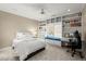 Bedroom boasts built-in shelving, a cozy window seat, and a dedicated workspace with a desk and chair at 303 Rolling Rock Se Rd, Marietta, GA 30067