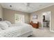 Bedroom featuring an ensuite bath, a ceiling fan, and a flat-screen TV creating a relaxing retreat at 303 Rolling Rock Se Rd, Marietta, GA 30067