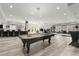 Finished basement with a billiard table and statement lighting creates an inviting space for fun and games at 303 Rolling Rock Se Rd, Marietta, GA 30067